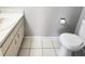 A simple, clean bathroom with white fixtures and tile flooring at 7148 E Bank Dr # 7148, Tampa, FL 33617