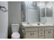 Bright bathroom with dual sinks, large mirror, and tile flooring at 7148 E Bank Dr # 7148, Tampa, FL 33617