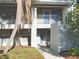Condo with two stories, with a tree and stairs leading to the second floor at 7148 E Bank Dr # 7148, Tampa, FL 33617
