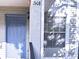 A front exterior view showcases the door and window under natural shadow at 7148 E Bank Dr # 7148, Tampa, FL 33617