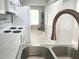 An updated kitchen with white appliances and a view into the living area at 7148 E Bank Dr # 7148, Tampa, FL 33617