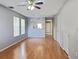 Bright living room features hardwood floors, gray paint, and a ceiling fan at 7148 E Bank Dr # 7148, Tampa, FL 33617