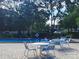 Outdoor pool area with tables and chairs, perfect for relaxing and enjoying the community amenities at 7148 E Bank Dr # 7148, Tampa, FL 33617
