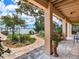 Covered back porch with water views and manicured landscaping at 8 Sunset Bay Dr, Belleair, FL 33756