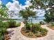 Backyard with lush landscaping and beautiful water views at 8 Sunset Bay Dr, Belleair, FL 33756
