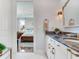 En-suite bathroom with double vanity, granite countertop, and modern lighting at 8 Sunset Bay Dr, Belleair, FL 33756