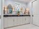 Bathroom vanity with double sinks, blue granite countertop, and decorative lighting at 8 Sunset Bay Dr, Belleair, FL 33756