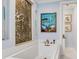 Elegant soaking tub with stylish fixtures and decorative wall art at 8 Sunset Bay Dr, Belleair, FL 33756