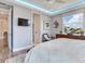 Bedroom featuring a ceiling fan, windows with blinds, and a flatscreen TV at 8 Sunset Bay Dr, Belleair, FL 33756