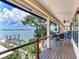 Waterfront deck with awning offers stunning river views and ample space for outdoor dining and relaxation at 8 Sunset Bay Dr, Belleair, FL 33756