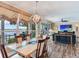 Open-concept dining and living space with water views and stylish furnishings at 8 Sunset Bay Dr, Belleair, FL 33756