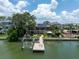 Waterfront home with a boat dock and lift, solar panels, lush landscaping and beautiful patio at 8 Sunset Bay Dr, Belleair, FL 33756