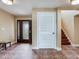 Inviting foyer with patterned tile flooring, staircase, and an elegant front door at 8 Sunset Bay Dr, Belleair, FL 33756