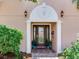 Covered front entrance with beautiful glass windows and detailed trim at 8 Sunset Bay Dr, Belleair, FL 33756