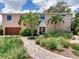Beautiful two story home with mature landscaping and a brick walkway at 8 Sunset Bay Dr, Belleair, FL 33756