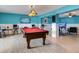 Entertainment space featuring a pool table, custom lighting, and an entertainment center at 8 Sunset Bay Dr, Belleair, FL 33756