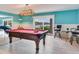 Billiards room with a red felt pool table, scenic water view, and bar stools at 8 Sunset Bay Dr, Belleair, FL 33756