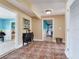 Hallway with an accent wall, tile floors, and doorways leading to other rooms at 8 Sunset Bay Dr, Belleair, FL 33756