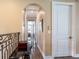 Hallway features a decorative table, dark wood floors, and arched entryway at 8 Sunset Bay Dr, Belleair, FL 33756