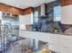 Modern kitchen with blue granite counters and stainless steel appliances at 8 Sunset Bay Dr, Belleair, FL 33756