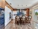 Kitchen island with bar seating, designer backsplash, and stainless appliances at 8 Sunset Bay Dr, Belleair, FL 33756