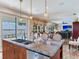 Open kitchen with an island and view to living and dining areas at 8 Sunset Bay Dr, Belleair, FL 33756