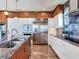 Island kitchen featuring stainless steel appliances and two-tone cabinets at 8 Sunset Bay Dr, Belleair, FL 33756