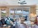 Living room with large windows overlooking the water and comfortable seating at 8 Sunset Bay Dr, Belleair, FL 33756