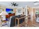 Open concept living room with hardwood floors, tv, and comfortable seating at 8 Sunset Bay Dr, Belleair, FL 33756