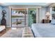 Tranquil bedroom with a private balcony and expansive water views, perfect for serene mornings at 8 Sunset Bay Dr, Belleair, FL 33756