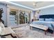Luxurious main bedroom with water views and terrace access, offering a serene and private retreat at 8 Sunset Bay Dr, Belleair, FL 33756
