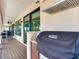 Covered outdoor kitchen on the deck, complete with a grill for waterfront entertaining and gatherings at 8 Sunset Bay Dr, Belleair, FL 33756