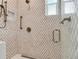 Detailed view of the shower featuring beautiful mosaic tile, a niche, and bronze fixtures at 8 Sunset Bay Dr, Belleair, FL 33756