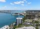 Aerial view of white condominiums complex near water and cityscape on a sunny day at 80 Rogers St # 3A, Clearwater, FL 33756