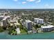 An aerial perspective of waterfront high-rise condos enveloped by verdant landscapes and adjacent to the waterfront at 80 Rogers St # 3A, Clearwater, FL 33756