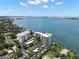 Breathtaking aerial shot of beachfront condominium complex surrounded by sparkling blue waters and city views at 80 Rogers St # 3A, Clearwater, FL 33756