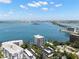 Breathtaking aerial view overlooking waterfront condos with city skyline in the distance under a bright blue, partly cloudy sky at 80 Rogers St # 3A, Clearwater, FL 33756
