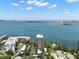 High-angle daytime view featuring white condos with parking and a beautiful ocean and cityscape at 80 Rogers St # 3A, Clearwater, FL 33756