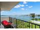 Exterior balcony with furniture featuring tranquil water and city views on a bright, sunny day at 80 Rogers St # 3A, Clearwater, FL 33756