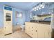 Well-lit bathroom featuring a vanity with a granite countertop and tiled floors and walls at 80 Rogers St # 3A, Clearwater, FL 33756