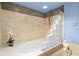 Bright bathroom with tiled shower featuring glass brick and tile details at 80 Rogers St # 3A, Clearwater, FL 33756