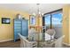 Cozy dining area featuring a glass-top table, stylish chairs, and water views at 80 Rogers St # 3A, Clearwater, FL 33756