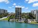 An exterior shot of a high-rise building with a pool and parking, near the water and local surroundings at 80 Rogers St # 3A, Clearwater, FL 33756