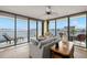 Bright living room with waterfront views from expansive windows and comfortable seating at 80 Rogers St # 3A, Clearwater, FL 33756