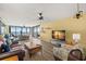 Spacious living room with water views, a ceiling fan, and comfortable seating at 80 Rogers St # 3A, Clearwater, FL 33756