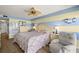 Comfortable main bedroom with a large bed, a sitting area and a relaxing view of the water at 80 Rogers St # 3A, Clearwater, FL 33756