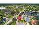 Aerial view pinpointing a home with well-kept lawns, a private pool, and is situated near a school at 8005 Pepperidge Ln, Port Richey, FL 34668
