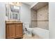 Bathroom with single sink vanity, tiled floor, and tiled shower/tub combination at 8005 Pepperidge Ln, Port Richey, FL 34668