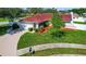 Charming single Gathering home with mature landscaping, a driveway, and a well manicured lawn at 8005 Pepperidge Ln, Port Richey, FL 34668