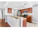 Modern kitchen featuring granite countertops, stainless steel appliances, and dark wood cabinetry with breakfast bar at 8005 Pepperidge Ln, Port Richey, FL 34668